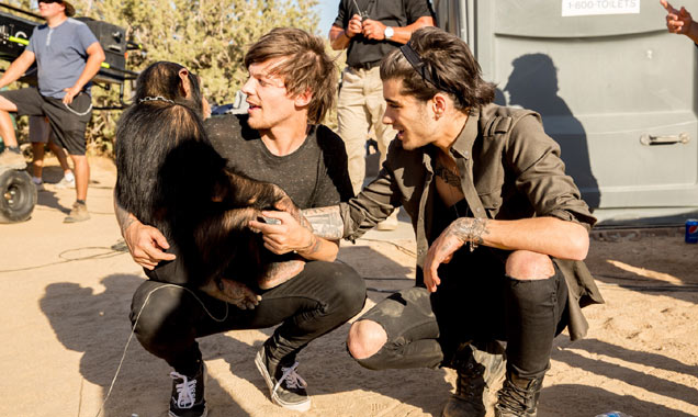 Harry Styles and Louis Tomlinson cuddle a chimp on 'Steal My Girl' set