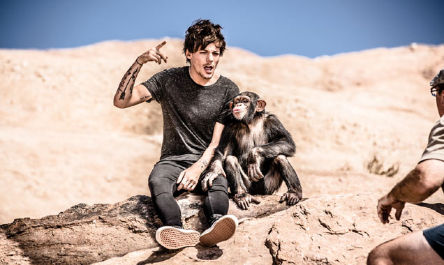 Louis Tomlinson from One Direction and a chimp on 'Steal My Girl' set