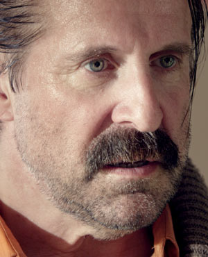 Mr. Olivetti played by Peter Stormare in Small Apartments