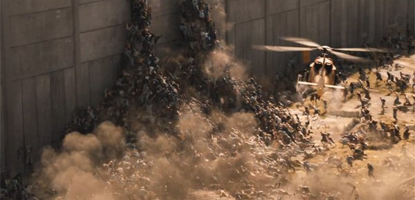 Zombies attempt to climb over a wall in World War Z