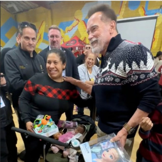 Arnold Schwarzenegger hands out Christmas gifts as he reflects on 'inclusion' when he moved to the US
