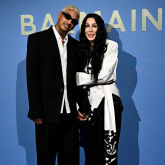 Back on! Cher confirms she’s back with toyboy lover Alexander ‘AE’ Edwards by getting cosy with him at Paris fashion show