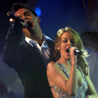 Robbie Williams hints at Kylie Minogue Kids duet at AFL Grand Final