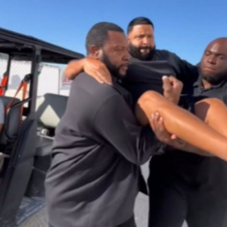 DJ Khaled gets security guards to CARRY HIM to stage to avoid getting sneakers dirty