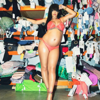 Another steamy baby bump snap! Heavily pregnant Rihanna poses in peach lingerie as she waits for new arrival