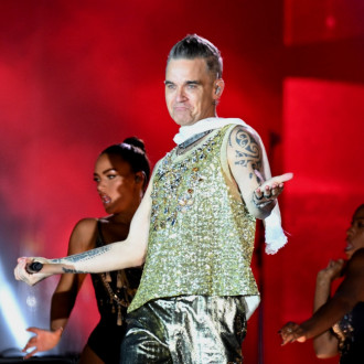 Robbie Williams reveals embarrassing incident live on stage: 'I was in a precarious position...'