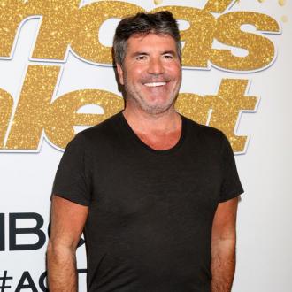 Simon Cowell back to work after breaking his back