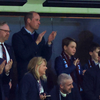 William, Prince of Wales takes Prince George to football match